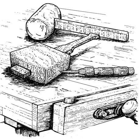 Collection of mallets on a workbench.